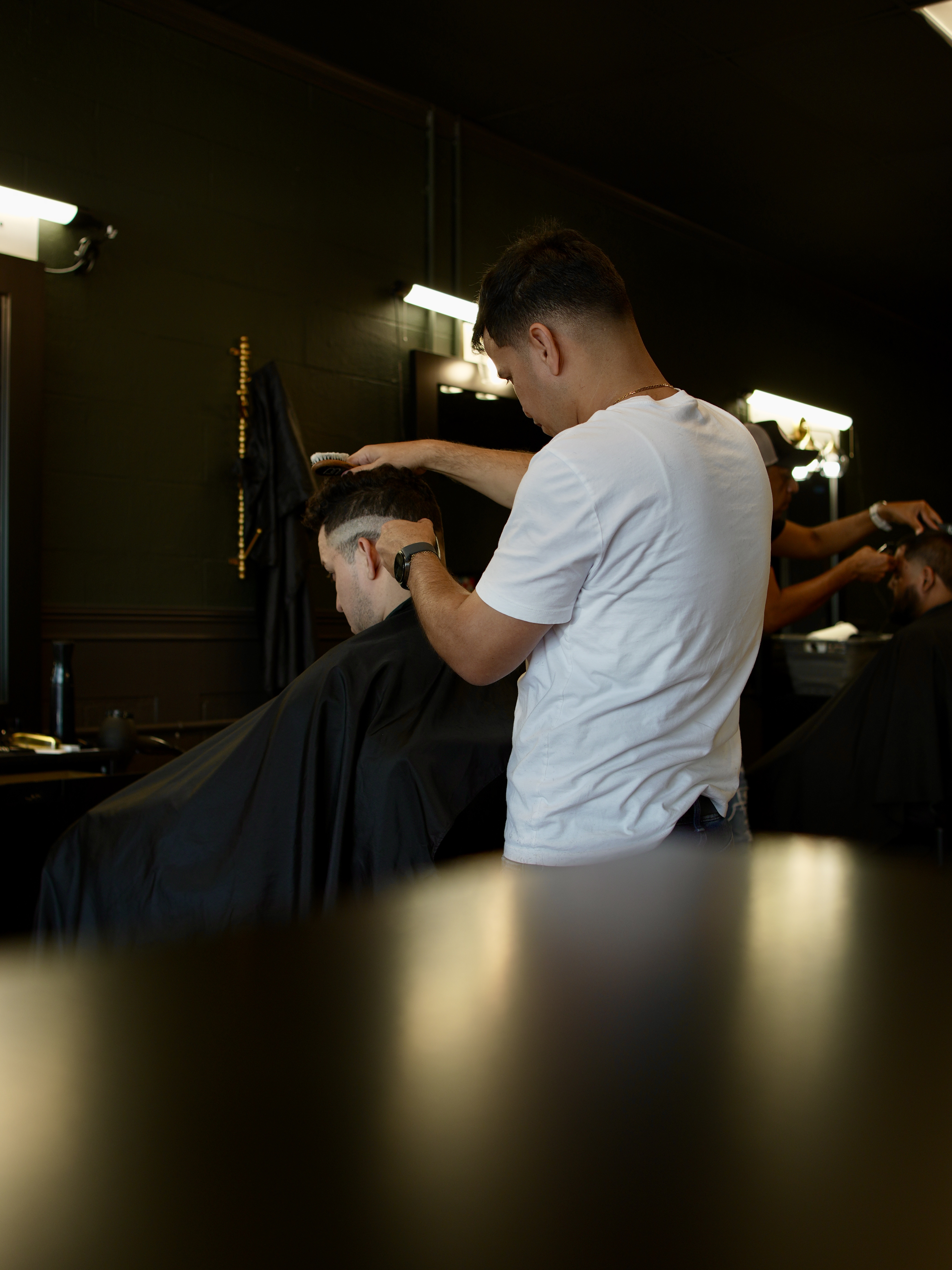Barber cutting a client's hair inside Casablanca Cuts